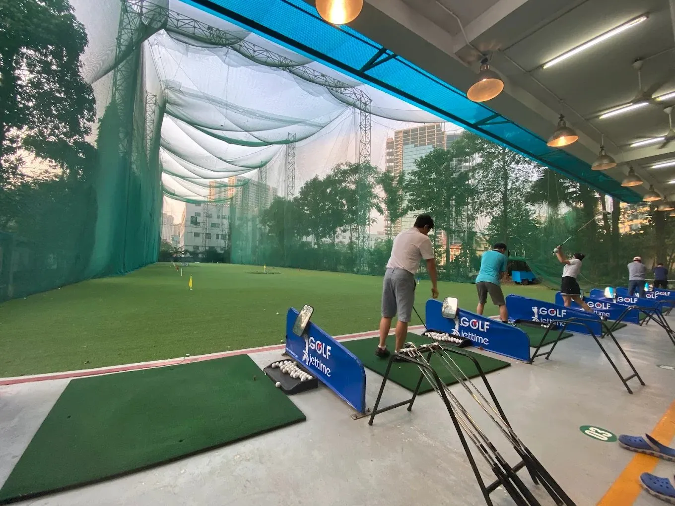 Driving range area of Viettime golf practice facility at sunset