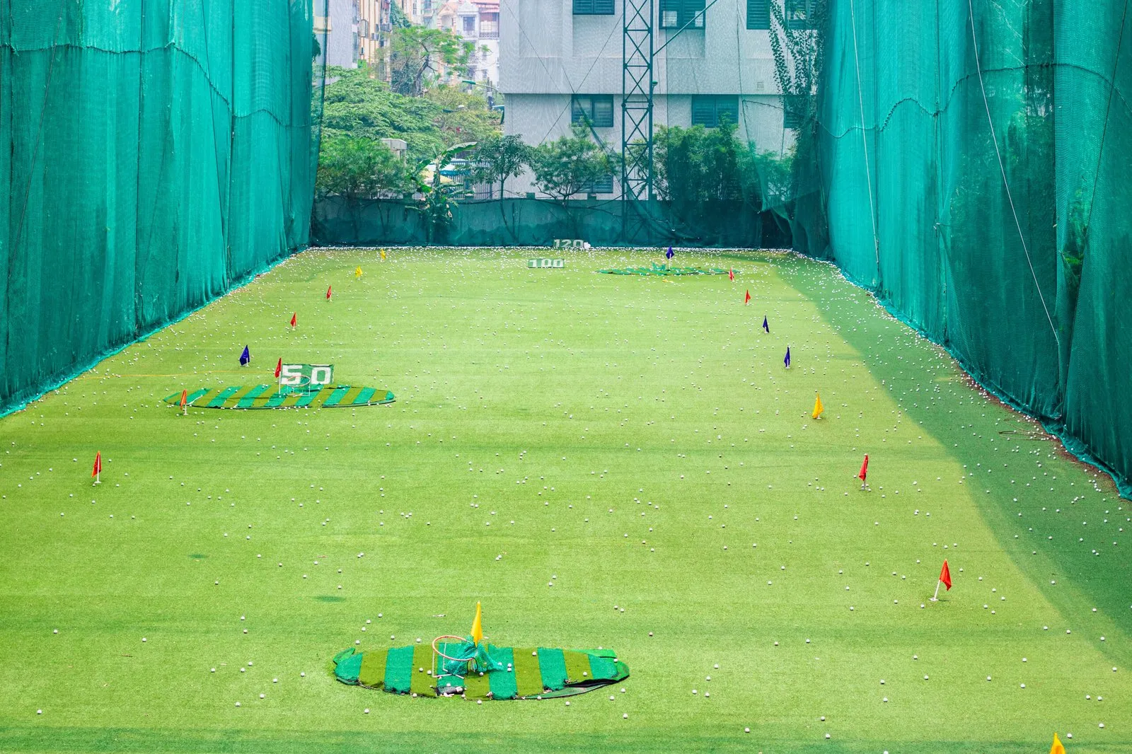 Driving range bay at Viettime golf driving range looking along the grass field